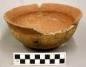 Ceramic partial bowl, flared rim, red pigment interior and at rim, repaired
