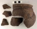 Ceramic jar sherds, incised body, flared rim, mended