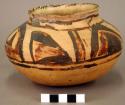 Ceramic jar, brown on yellow exterior, flared rim and flat base