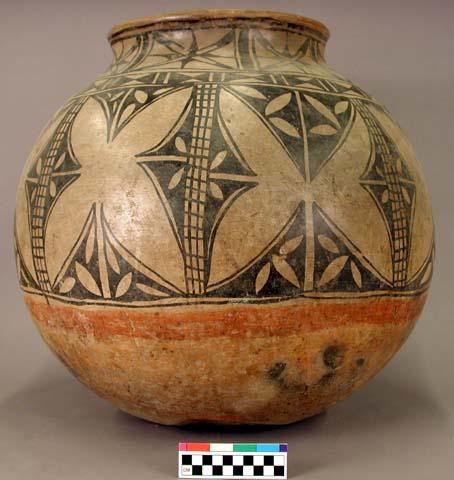 Large pottery storage jar. Globular, slightly out-curved rim, red base