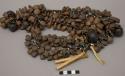 Necklace of seeds, beads, pingulyo reed and turtle bones