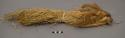 Grass bundles tied on string large enough to fit wrist (patesako)
