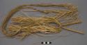 Headdress of buriti frond straw with no coloring, long streamer down the back -