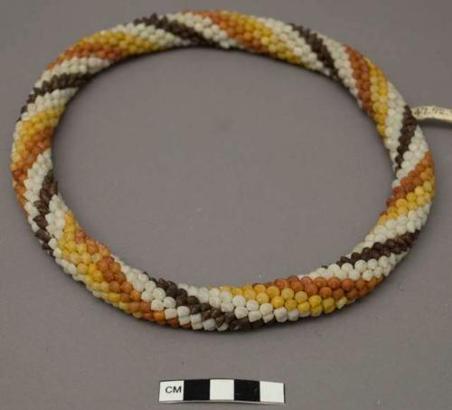 Hat band circlet of white, black, yellow and orange shells