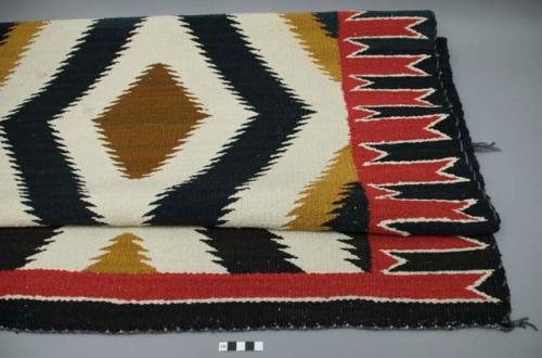 Rug; black, off-white, brown, dark brown and red wool