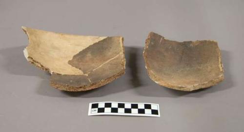 Potsherds and 5 red bowls; large red jar, fragmentary; bowl, incised decoration,