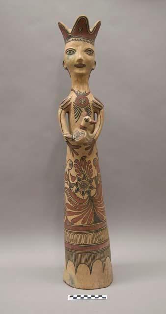 Ceramic "queen" figurine holding a bird