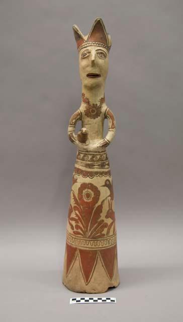 Ceramic "queen" figurine holding a bird