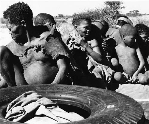 Oukwane, /Twikwe, Tsekue, and four others on top of expedition truck (print is a cropped image)