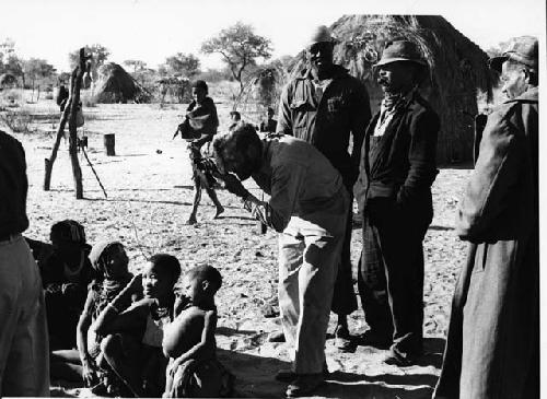 Group of people sitting, with Daniel Blitz taking a photograph