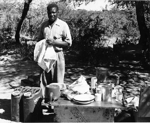 Philip Hameva standing next to his kitchen table at Theunis Berger's farm