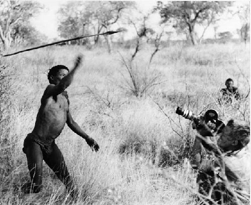 [No folder title]: ≠Toma throwing an assegai, being filmed by John Marshall (print is a cropped image)