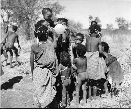 Group of children with a balloon given to them by Anneliese Scherz