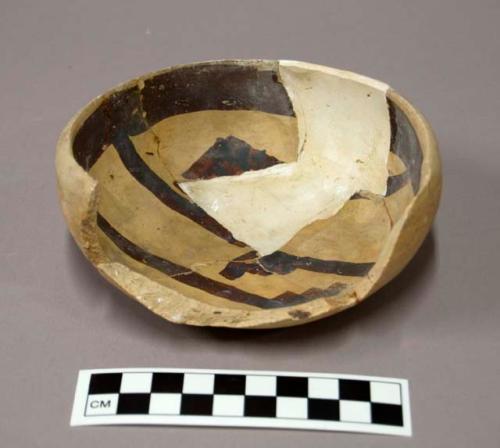 Restorable Awatovi black-on-yellow pottery bowl