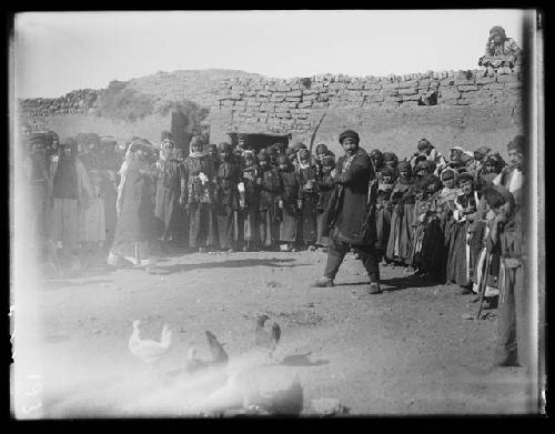 Circle of tribal people with chickens