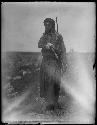 Man standing in field in traditional dress