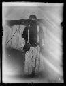 Man standing in front of tent in traditional clothing