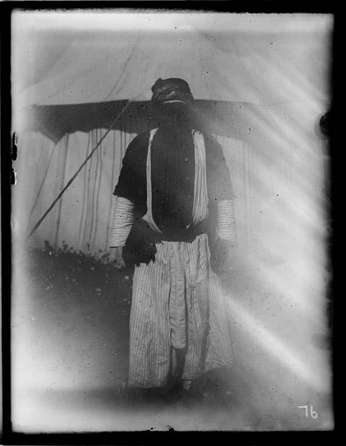 Man standing in front of tent in traditional clothing