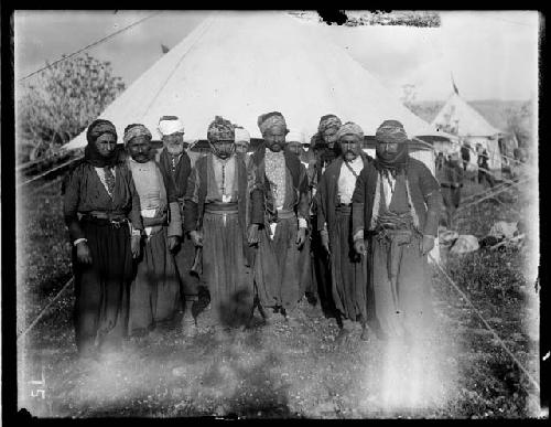 Tribal men in front of tent