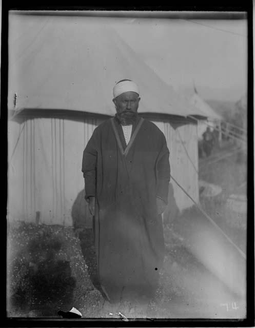 Tribal man standing in front of tent