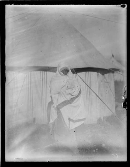 Tribal woman standing in front of tent