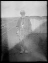 Man in traditional clothing in front of tent