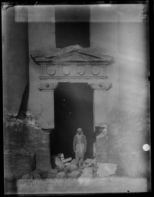 Man standing in facade ruin entryway