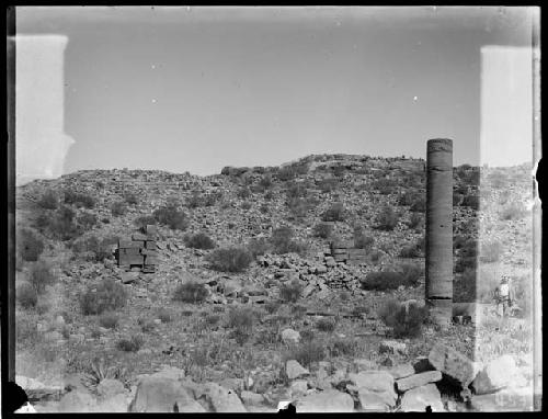 Man standing next to pillar and ruins