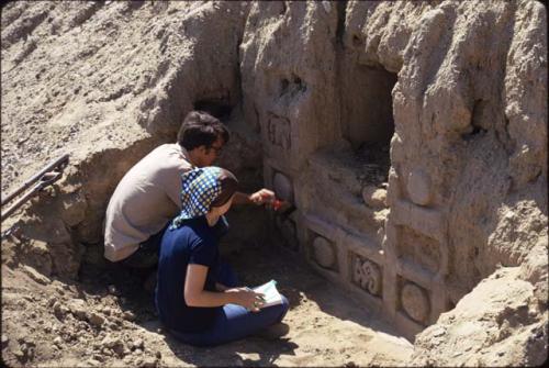 Sam Burr cleaning freize and wall niche, S wall central section entry court, Laborinto.