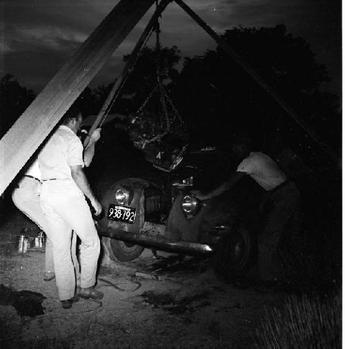 Men work at night on a truck