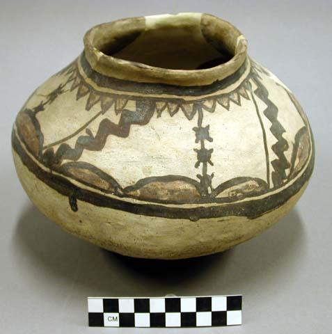 Complete jar, brown on brown exterior, conical base, reconstructed