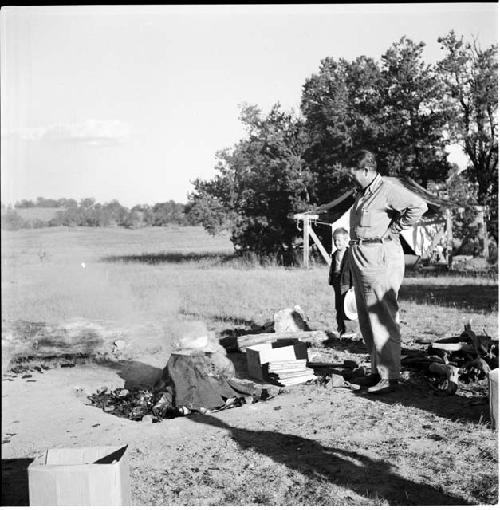 Man and boy standing at campsite