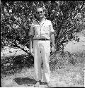 Man stands in front of tree