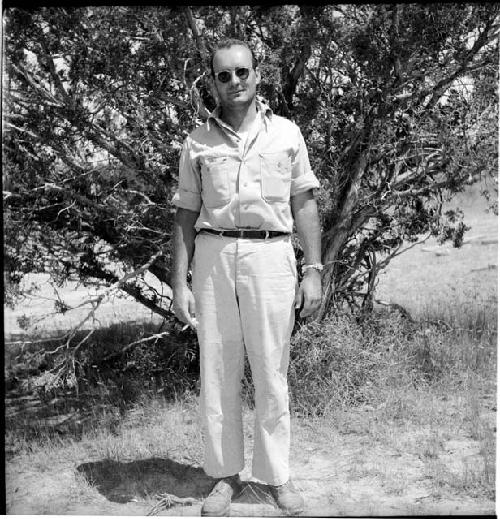 Man stands in front of tree