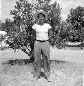 Man stands in front of tree