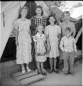 Group of adults and children poses for photo at excavation site