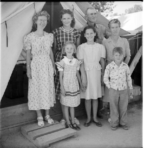 Group of adults and children poses for photo at excavation site