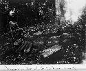 Man stands next to ruins of stairway