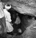 Workers go into a cave site