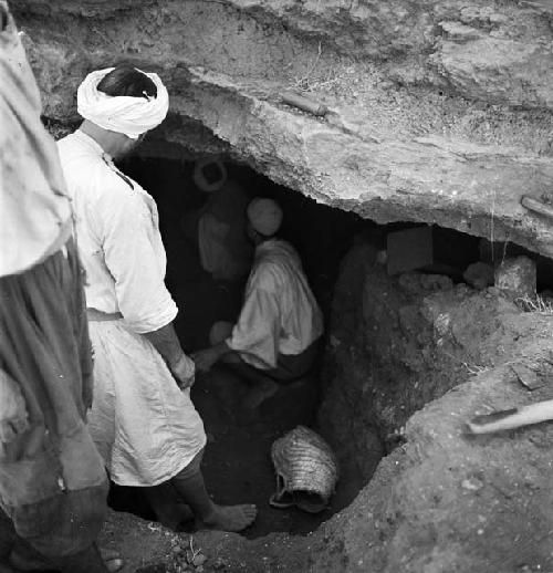 Workers go into a cave site