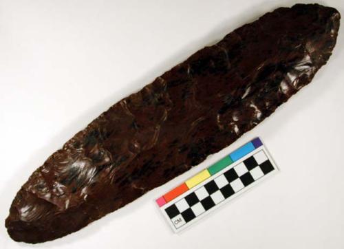 Chipped implement; chipped from red and black mottled obsidian