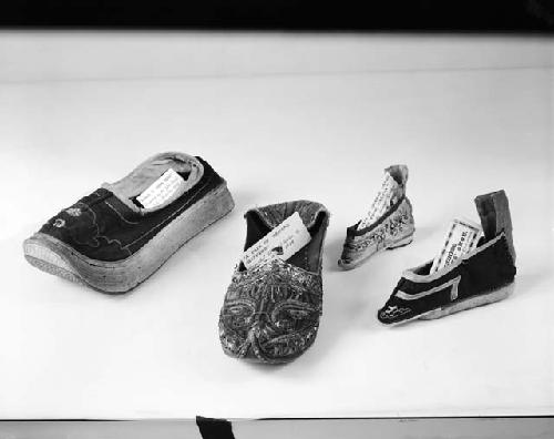 Chinese shoes and Bengali slipper (second from left)