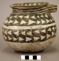 Black & white pottery vessel.  Contained bit of charcoal, A1894.