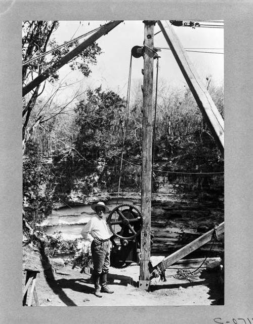 Sacred Cenote, Edward Thompson next to mechanical wheel