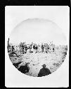 Men standing with pack horses