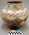 Pottery olla. Cream slip with brown and yellow and red designs--restored