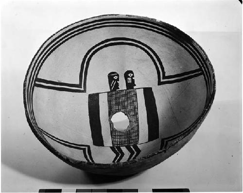 Bowl with human figures painted inside; small hole at bottom