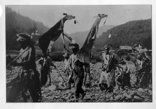 Two men holding flags march at head of line