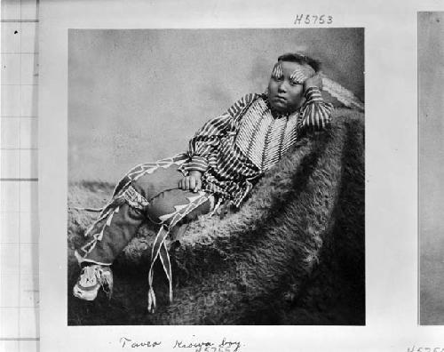 Portrait of young Kiowa boy, seated