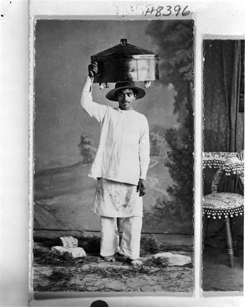 Man carrying vessel on his head